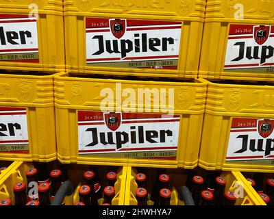 Liege, Belgium - March 3. 2022: Closeup of stacked beer crates with logo lettering of jupiler brewery Stock Photo