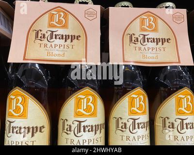 Liege, Belgium - March 3. 2022: Closeup of beer bottles with logo lettering of belgian la trappe brewery Stock Photo