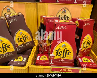 Liege, Belgium - March 3. 2022: Closeup of beer crates with bottles with logo lettering of belgian abbey brewery leffe in supermarket Stock Photo