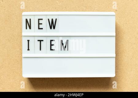 Lightbox with word new item on wood background Stock Photo