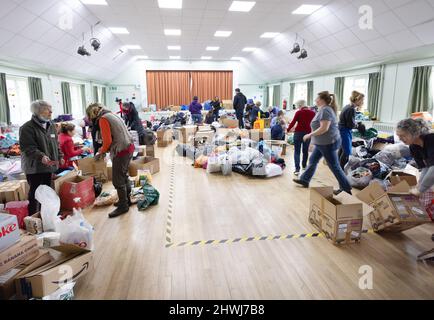 Ukraine aid; Volunteers sorting charitable donations for Ukrainian refugees from the Ukraine Russia war , 2022, Great Shelford Cambridgeshire UK Stock Photo