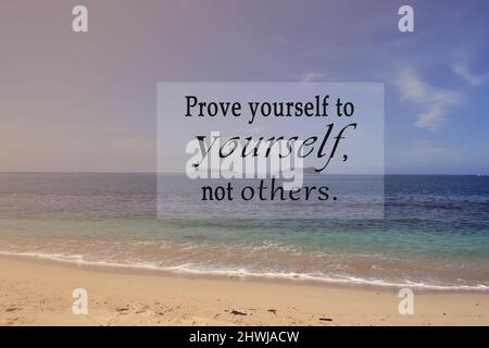 Motivational and inspirational quote on blurred background of blue ocean - Prove yourself to yourself, not others. Stock Photo