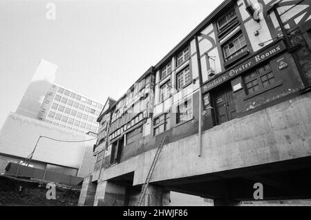 Manchester's oldest building, the Shambles, is rising to new heights, but it's not quite as easy as ganger man Pat Hegarty makes it look. The building has been raised five feet on hydraulic jacks and a service road to an underground car park is being taken underneath in the new city centre development area. 27th October 1971. Stock Photo