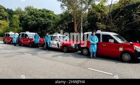 Hong Kong. 6th Mar, 2022. Taxi drivers of the 'anti-epidemic taxi' fleet pose for a photo in Hong Kong, south China, March 5, 2022. TO GO WITH 'Feature: Hong Kong taxi drivers join COVID-19 battle' Credit: Xinhua/Alamy Live News Stock Photo