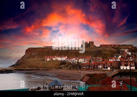 Dramatic view of St. Mary's Church, Whitby Abbey and the river from across River Esk at dusk in Whitby, North Yorkshire England United Kingdom Stock Photo