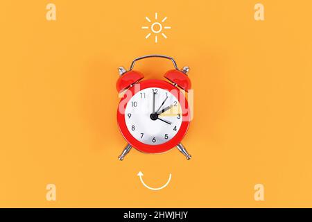 Concept for explaining summer daylight saving time with clock and arrow Stock Photo