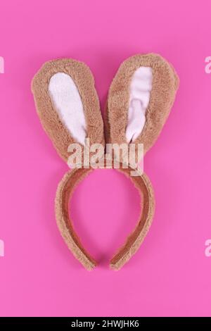 Cute costume easter bunny ears headband on pink background Stock Photo