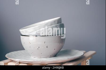 A set of beautiful plates in pastel colors on a gray background. Stock Photo
