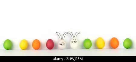 Happy Easter. Creative banner from multi-colored eggs in row and two funny rabbits. White background Stock Photo