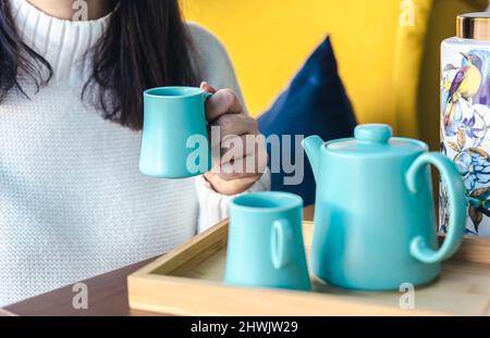 Teapot and two blue cups on the table, top view. Stock Photo