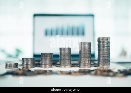 Hand putting money coins stack growing, saving money for finance accounting concept. Stock Photo
