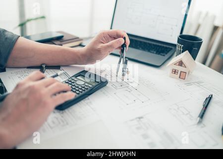 Architect engineer use compass drawing design working on bueprint. House planning design and construction concept. Stock Photo