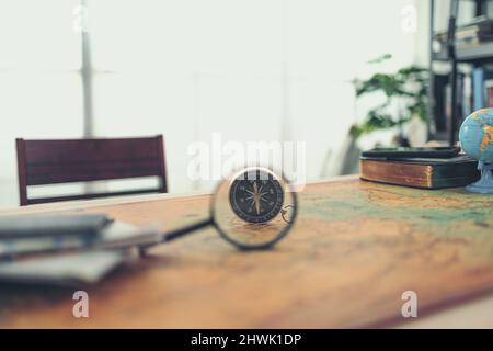 Magnifying glass and Magnetic compass on world map. Travel , Adventure and Discovery concept. Stock Photo