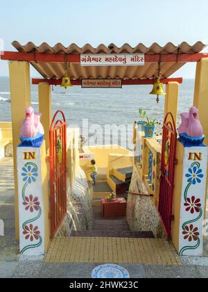 India, Gujarat, Island of Diu. Gangeshwar Mahadev Shiva temple entrance. Shivlingams with food offerings to Shiva washed out by the sea at high tide. Stock Photo