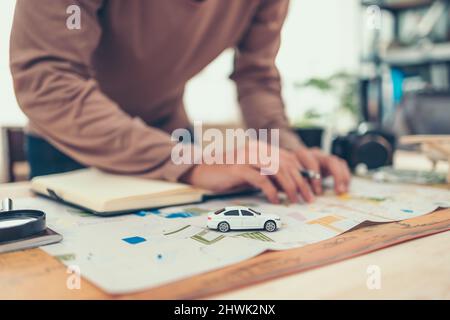 model car on road map and tourist planning before traveling in vocation, holidays or long weeked. Travel , Adventure and Discovery concept. Stock Photo