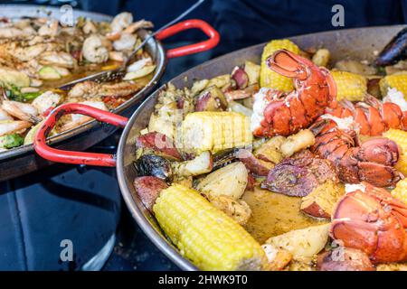 Everglades City Florida,Seafood Festival food,vendor stall booth lobster corn on cob potatos cooking pan Stock Photo
