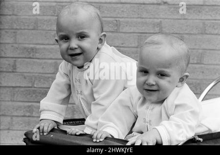 Twin sisters Anna (right) and Barbara Rozycki, at home in Coventry, like doing everything together. As playmates they're inseparable. The girls are a bonny pair now. But when they were born nearly a year ago last May there were fears for their survival, for the girls are Siamese twins. They were joined at the chest and abdomen. They day after they were born they had emergency surgery at Birmingham Children's Hospital. It was a great success. 16th May 1971. Stock Photo