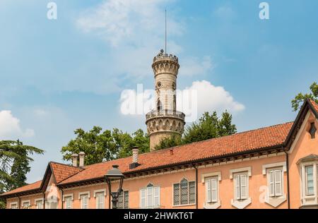 Facade of Villa Mirabello with tower Robbione within the complex of the gardens of the Estense Palace of Varese, Lombardy, Italy Stock Photo