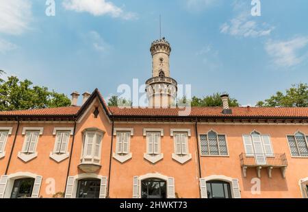 Facade of Villa Mirabello with tower Robbione within the complex of the gardens of the Estense Palace of Varese, Lombardy, Italy Stock Photo