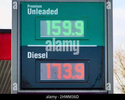 An LED sign at a UK fuel station forecourt on 6th March 2022 shows extremely high fuel prices.