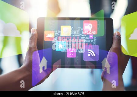 Connecting with the online world at work. Shot of an unrecognizable businesswoman using her digital tablet at work. Stock Photo