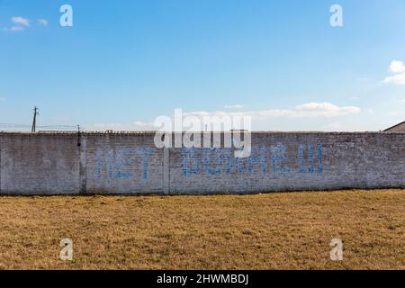 Graffiti with the inscription No war lasted less than a day. Unknown people immediately destroyed the graffiti. Stock Photo