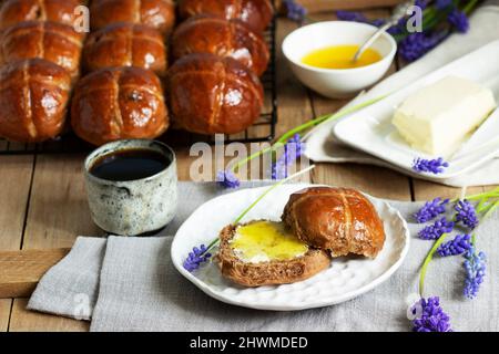 Chocolate cross buns served with butter and honey. Traditional Easter baking. Stock Photo