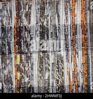 Texture of multi-colored homespun rug. Traditional rustic carpet with a striped pattern for use on floor Stock Photo