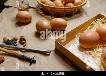 Tools for decorating Paschal eggs, Pysankas. Workplace. Rustic background. Collection of eggs. Homemade pen for drawing eggs. Preparation for holiday. Stock Photo