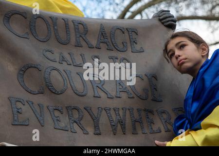 London, UK. 6th March 2022. A young protester stands next to the statue of suffragette Millicent Fawcett in Parliament Square where people have gathered to protest against Russia's invasion of the Ukraine and to call for an end of the war. Credit: Kiki Streitberger/Alamy Live News Stock Photo