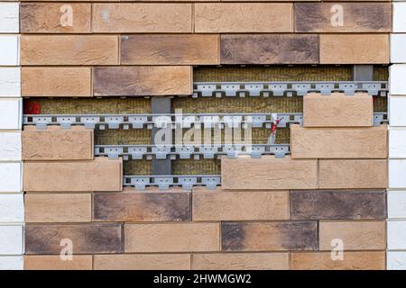 a fragment of a wall that is tiled with a break in it Stock Photo