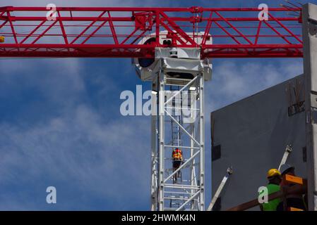 Building site crane and construction site workers on a building development in Bendigo, Victoria, Australia. Stock Photo