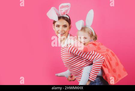 Happy easter. Two sisters hunting for Easter eggs. Girls with bunny ears. Stock Photo
