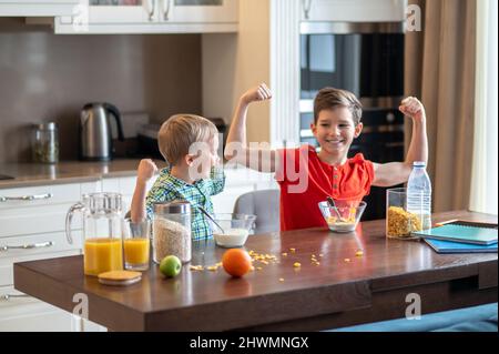 Kids showing their physical fitness after eating breakfast cereals Stock Photo