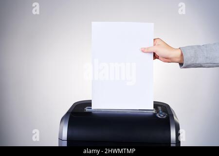 Just another addition to the paper trail. Studio shot of paper being shredded. Stock Photo