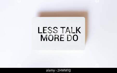 Less Talk more Do, written on a sticky note Stock Photo