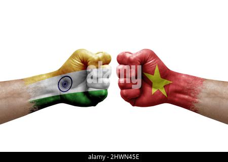 Two hands punch to each others on white background. Country flags painted fists, conflict crisis concept between india and vietnam Stock Photo