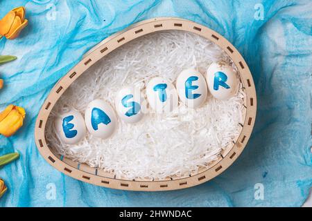 Happy easter time. Bright Easter holiday concept with spring flowers and easter eggs. Colorful Easter eggs background Stock Photo