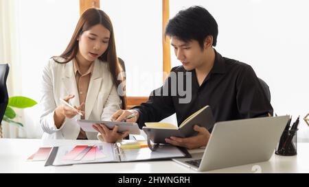 Two designers are working together, discussing their design plans and interior plans for the project Stock Photo