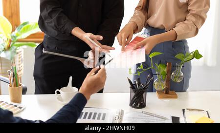 A professional designer team discuss and sharing their design idea in the meeting. cropped shot Stock Photo