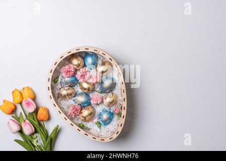 Happy easter time. Bright Easter holiday concept with spring flowers and easter eggs. Colorful Easter eggs background Stock Photo