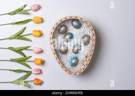 Happy easter time. Bright Easter holiday concept with spring flowers and easter eggs. Colorful Easter eggs background Stock Photo