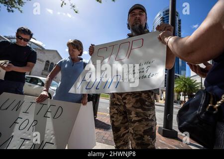 Orlando, United States. 06th Mar, 2022. Ukraine supporters holding signs during a rally in Orlando, Florida. The rally held to condemn President Vladimir Putin and Russia's invasion of Ukraine. Ukrainian President Volodymyr Zelensky called Ukrainians to fight back against the Russian invaders. Credit: SOPA Images Limited/Alamy Live News Stock Photo