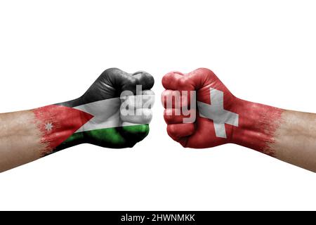 Two hands punch to each others on white background. Country flags painted fists, conflict crisis concept between jordan and switzerland Stock Photo