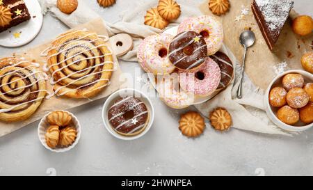 Desserts assortment on light background. Freshly made bakery and treats. Flat lay, top view, copy space Stock Photo