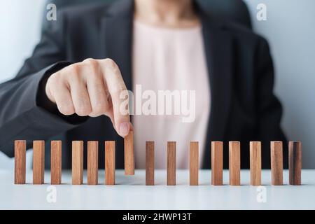 Businesswoman hand pulling leader man wooden from crowd of block. Toxic People, Human resource management, Recruitment, Teamwork and leadership Concep Stock Photo