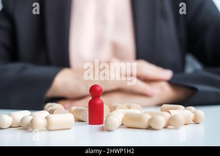 Businesswoman hand pulling leader man wooden from crowd of employees. Toxic People, Human resource management, Recruitment, Teamwork and leadership Co Stock Photo