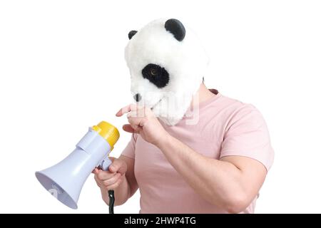 Man wearing a panda mask head turning on the megaphone, isolated. Stock Photo