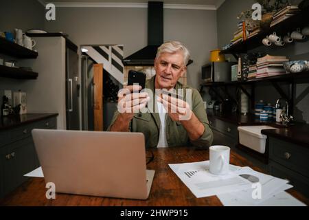 Caucasian male working from home making online payment Stock Photo