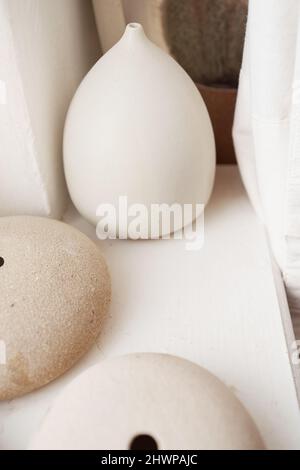 Three empty handmade earthenware products in pottery shop Stock Photo